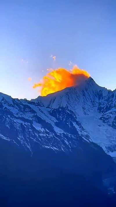 Amazing illusion of flames burning on the top of the mountain.