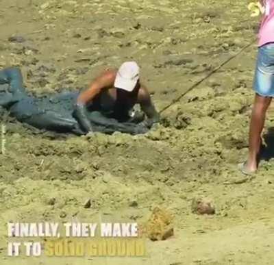 Guy wades through mud to rescue the poor Impala.