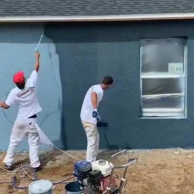 Spray painting a house