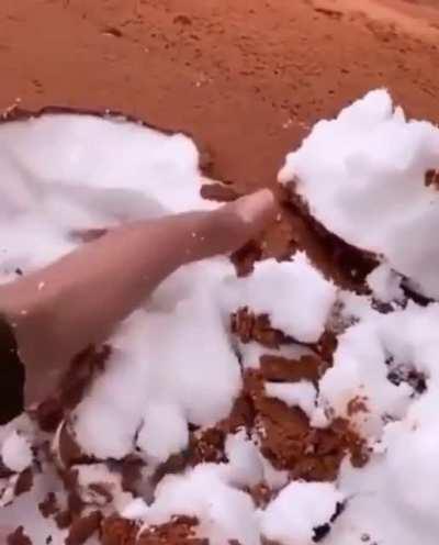 Sand covered snow in the desert in Saudi Arabia