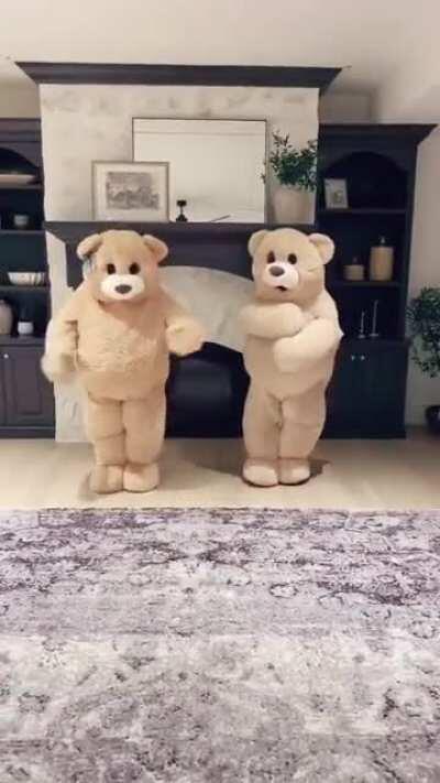 Two dancing teddy bears having fun together.