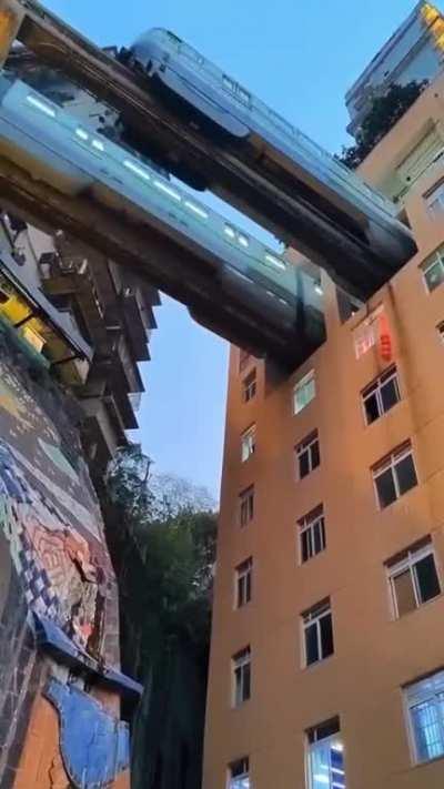 Train passes through a residential building in Chongqing, China