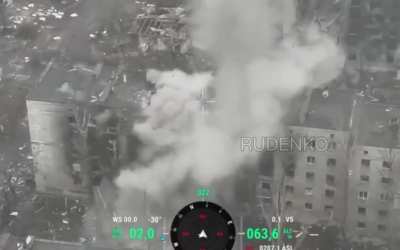 Russian solider drops TMK anti-tank mine through a roof opening on a building where Ukrainian personnel are positioned. Toretsk area.