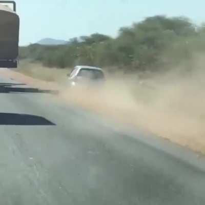 Small car overtaking a big truck and going offroad