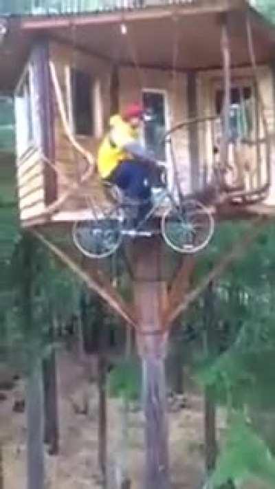 Guy cycling to his tree house