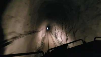 A lakeside ride through a tunnel on a freight train