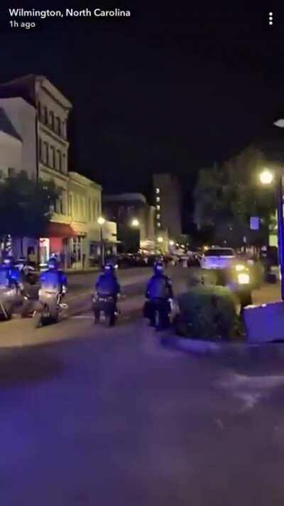 Police in Wilmington, North Carolina kneeling.