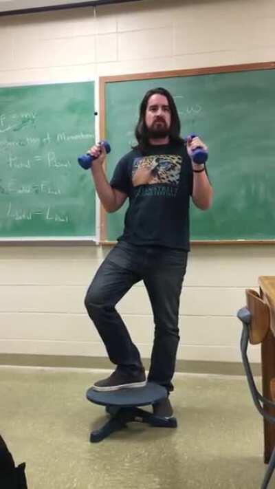 High school teacher wows his students with a real life demonstration for Conservation of angular momentum