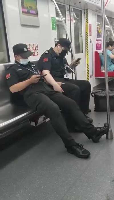 Chinese policemen celebrating pride month on the subway