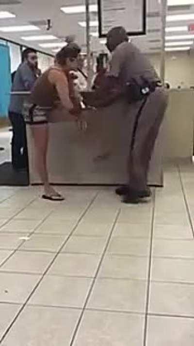 Girl tries to kick a cop in the balls at the DMV in Deerfield Beach, Florida