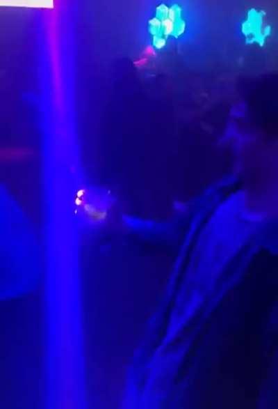 This guy perfectly times a light in his cup at a club and I can't stop watching