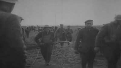 German POWs carries wounded American soldiers to the dressing station in Missy-Aux-Bois, France (July 16, 1918)