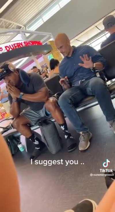 Bro gets upset when someone sits next to him at the airport terminal.