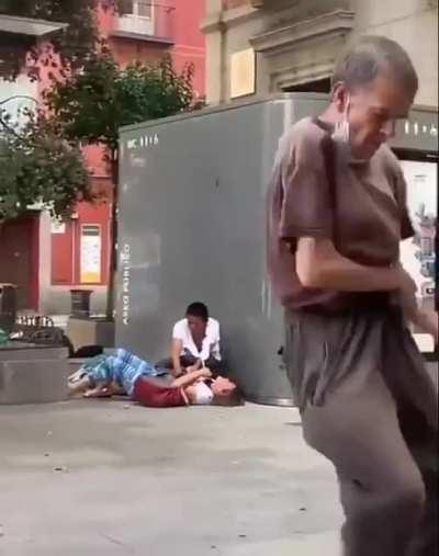 A woman is being mugged and this mentally ill homeless is dancing...