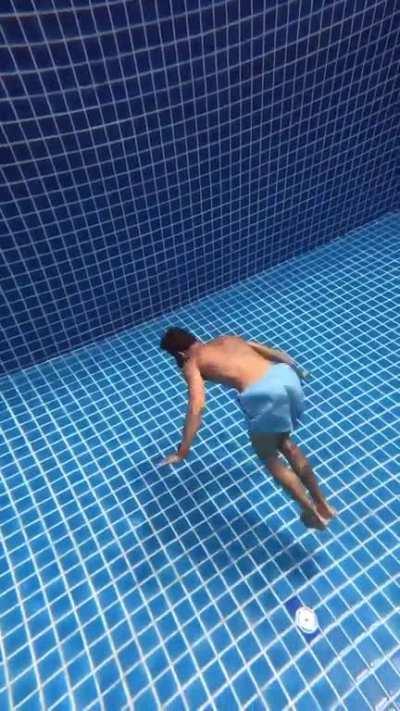 Man doing gymnastics underwater