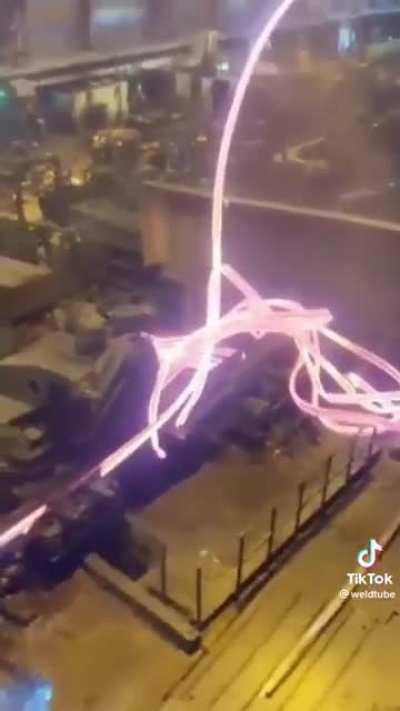 Hot steel jumps out of the roller at a steel mill