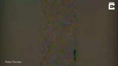 Humanoid filmed floating over house