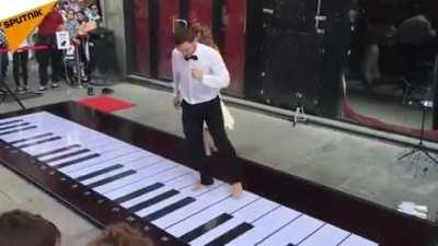 Playing the pink panther theme with feet. Impressive!