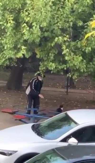 This grandpa and kitty having fun at the park