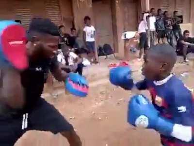 Young Kid Boxer with his trainer