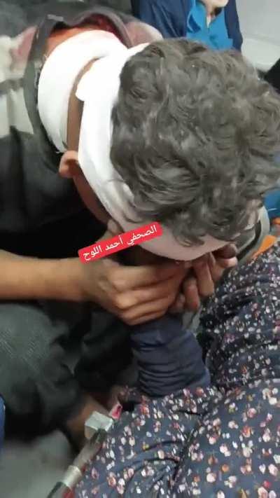 A child kissing his mother’s hand: Please stay with me after their home was bombed by israel in Gaza