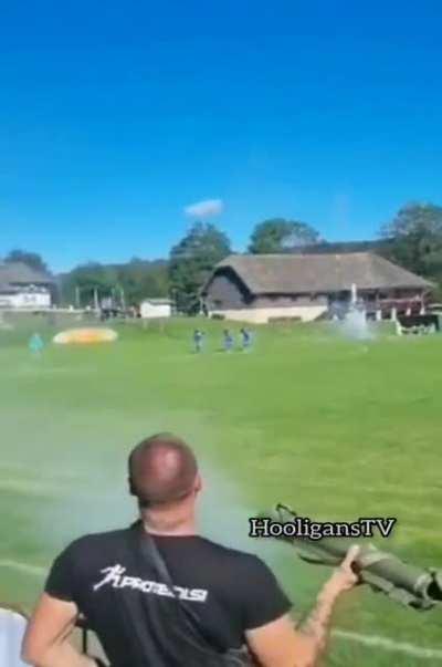 Fan in a lower division Croatian League fires a grenade launcher during a game