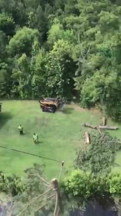 Tree topper uses a zip line technique to bring felled tops to shoreline