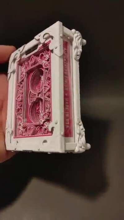 I cut playing cards into 3D art using an xacto. I used pink cards on this one and gave it a jewelry box look.