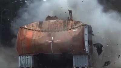 Shipping container meets 120mm high explosive shell