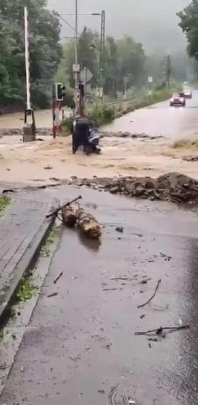 Man loses his bike after heavy thunderstorms cause flooding in Germany.