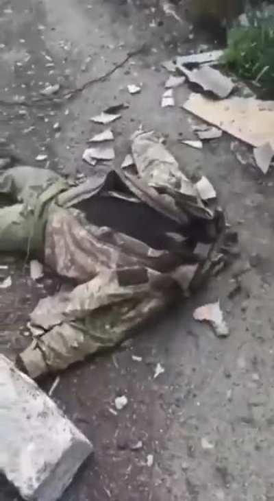 NSFW. Ukrainian soldier beheaded. Head and hands on spike above him. Unknown location