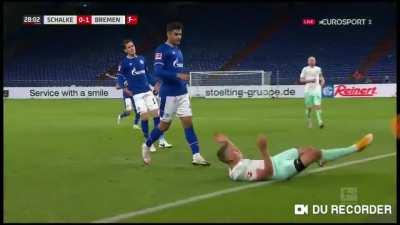 Schalke's Ozan Kabak spits at an opponent after fouling him.