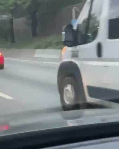 This guy riding a scooter on the highway