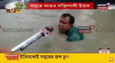 Reporter Stands As People Pretend to Drown