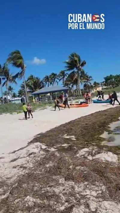 Illegal Cuban immigrants landing on the shores of Florida in a makeshift boat