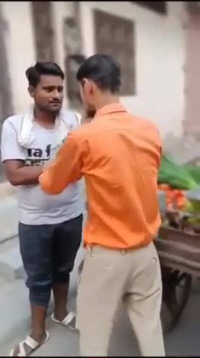 Hindu man abuses a Muslim street vendor and falsely accuses him of being an outsider.