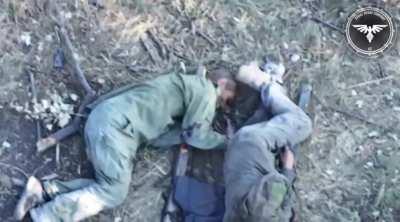 Russian soldier sitting next to his wounded comrade freeze up after hearing a drone, moments later the FPV drone hits near the soldiers causing fatal injuries. Video by the Strike Drone Company (47 OMBr)