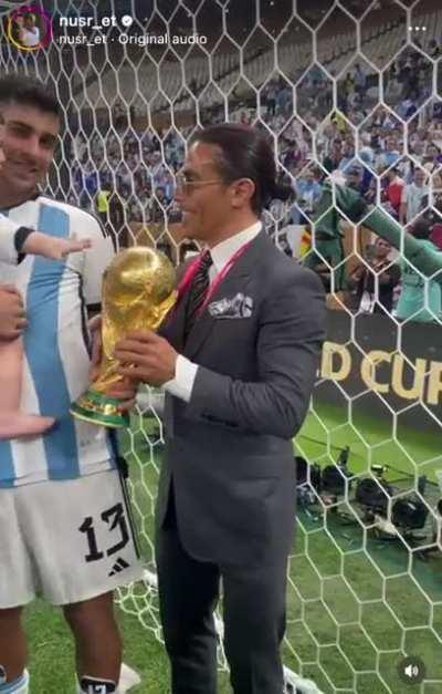 “Salt Bae” prying the World Cup trophy from Cristian Romero and his son.