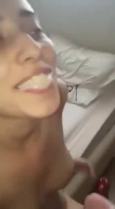 Smiling with a mouthful of cum