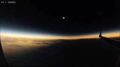 The view of a solar eclipse from an aircraft in flight