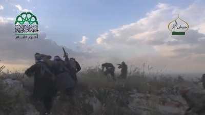 Syrian Islamist rebels rush out of their cover and charge into a pro-regime held checkpoint after weakening the defenses via shelling and a tunnel bomb. Ariha, Syria. [May 12th, 2015]