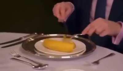 Etiquette specialist demonstrates how The Queen would eat a banana.