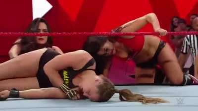 The Bella Twins attack Ronda and pose over her