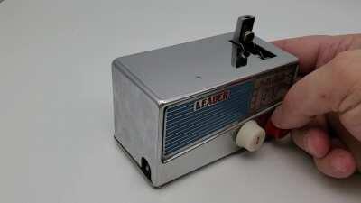 A fun radio looking occupied japan table lighter and cigarette dispencer.