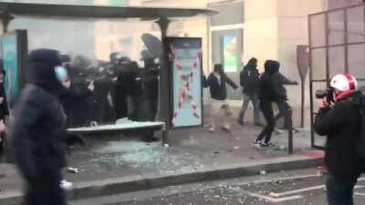 Protesters storming the Bastille, using umbrellas to block police munitions (11.28)