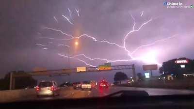 Crazy lightning stretches across the sky.