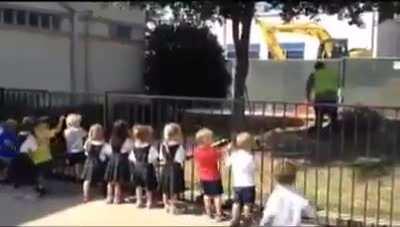 Kids cheer every time a construction workers shovels dirt.