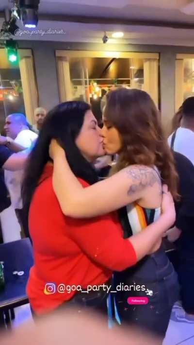 The age gap doesn't matter for these two women. Hooking up in front of everyone at a party.