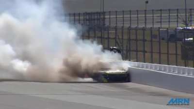 NASCAR racecar erupts in flames after fuel line bursts mid race, driver escapes miraculously from said moving car after being inside its burning cockpit for almost half a minute. He suffered second degree burns across his neck, face, right arm, hands and 