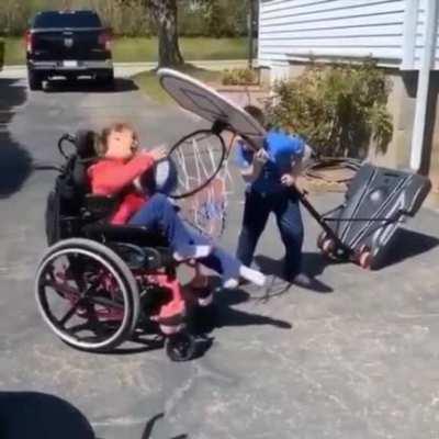 This brother is helping his sister to make the shot!